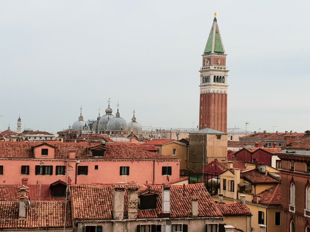 View of rooftops over venice with st mark's tower and basillica in background