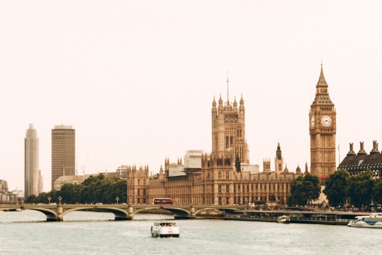 View of Houses of Parliament. Big Ben and Westminster Abbey in distance from The Thames river