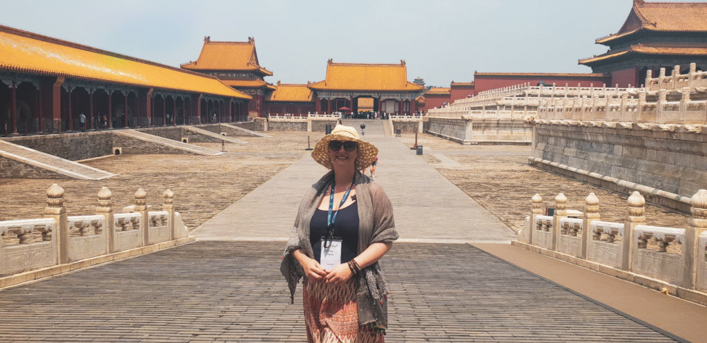 Woman wearing straw hat standing in the Forbidden City