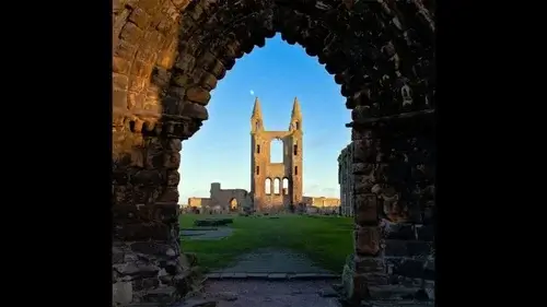 Day Trips from Edinburgh Image of Stone arch in gothic style with view of ruin of cathedral in distance