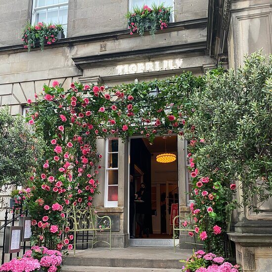 Entrance to Tiger Lily decorated with foliage and pink flowers