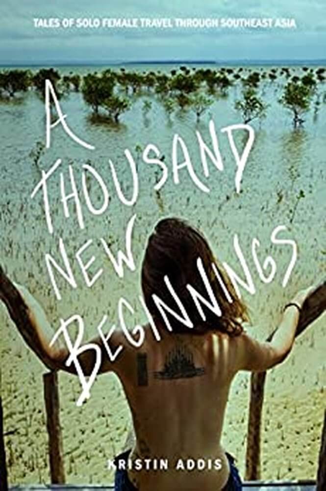 Travel books
Cover of A Thousand New Beginnings by Kristen Addis, tagline - tales of solo travel through south east asia in white on background of woman sat on steps facing out towards  a sandy tree lined area