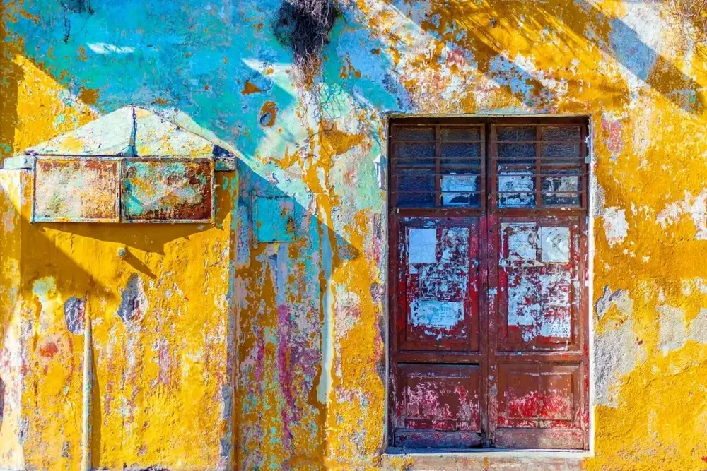 Second city Antigua, Gauatemala, a beautiful faded yellow building with red doors