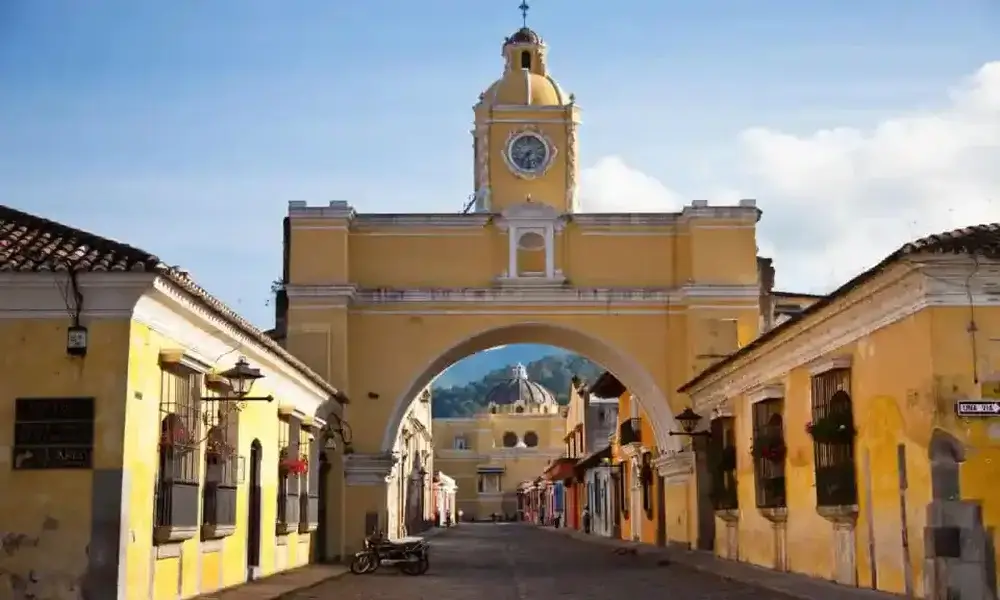 Second city Antigua, Guatemala.  El Arco de Santa Catalina. A yellow building with an arch over a road