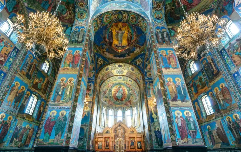 Interior of Church of the Spilled Blood, painted murals cover walls and ceiling in blues and gold