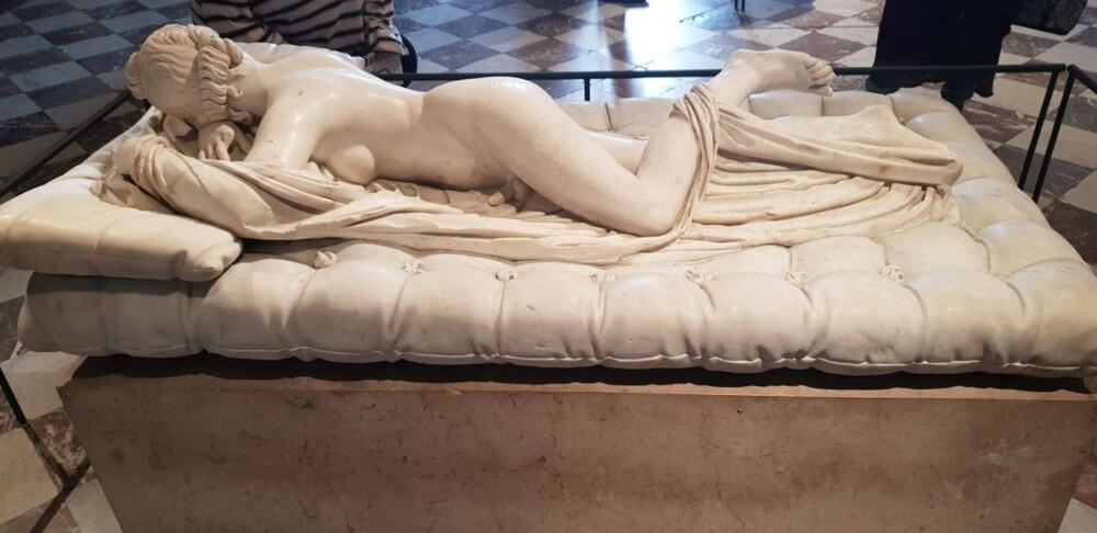 Musings from Paris Statue of Sleeping Hermaphrodite in cream marble.  Naked figure lying on cushion with a draped sheet