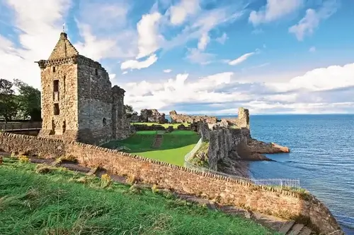 Day Trips from Edinburgh In search of ruins 
Ruin of stone castle set on clifftop, surrounded by green grass, blue sea below and sky above