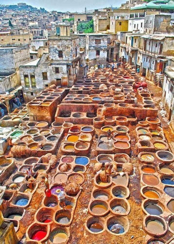 Second city Fez, Morocco.  Chouara Tannery vats of coloured dye with men working