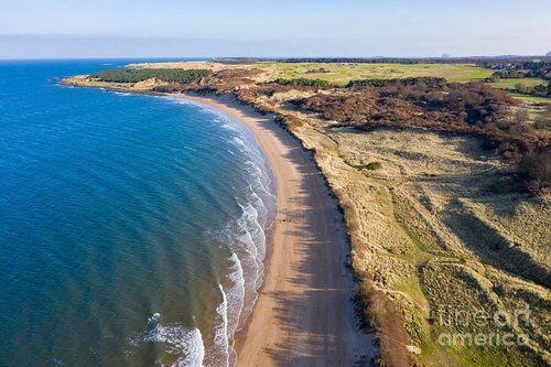 Drone shot overhead of Gullane beach, green dunes and blue sea