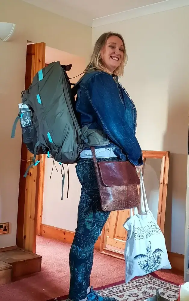Hello blogging world. Woman, the author carrying a rucksack in her home prior to leaving on her 1st solo trip
