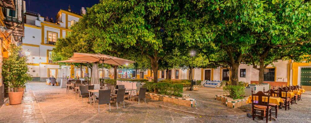 Second city Seville, Plaza de  Dona Elvira, tables sat out in square under trees