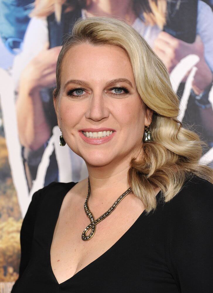 Head and shoulder shot of Cheryl Strayed, an inspirational women with blonde hair black v neck dress and necklace