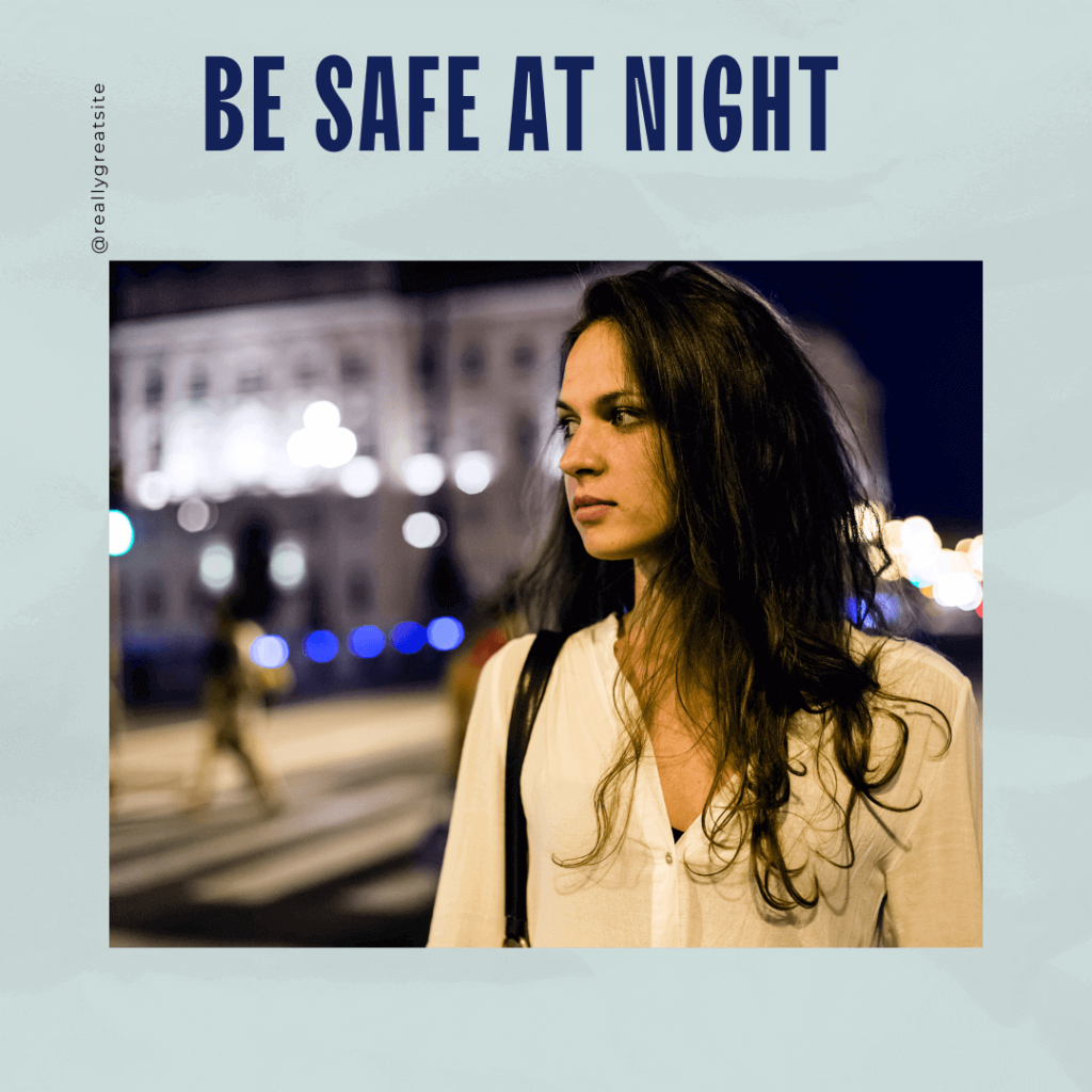 Advice for evenings, be safe at night, dark haired woman walking along street with streetlights