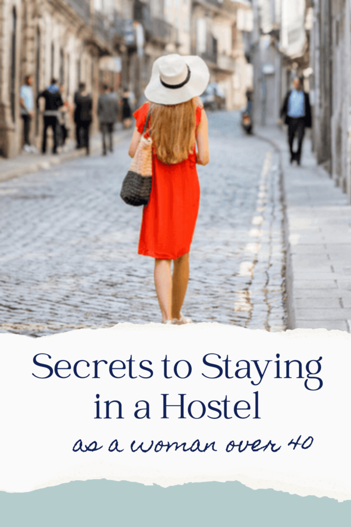 Secrets to staying in a hostel as a woman over 40 image of confident woman in red dress