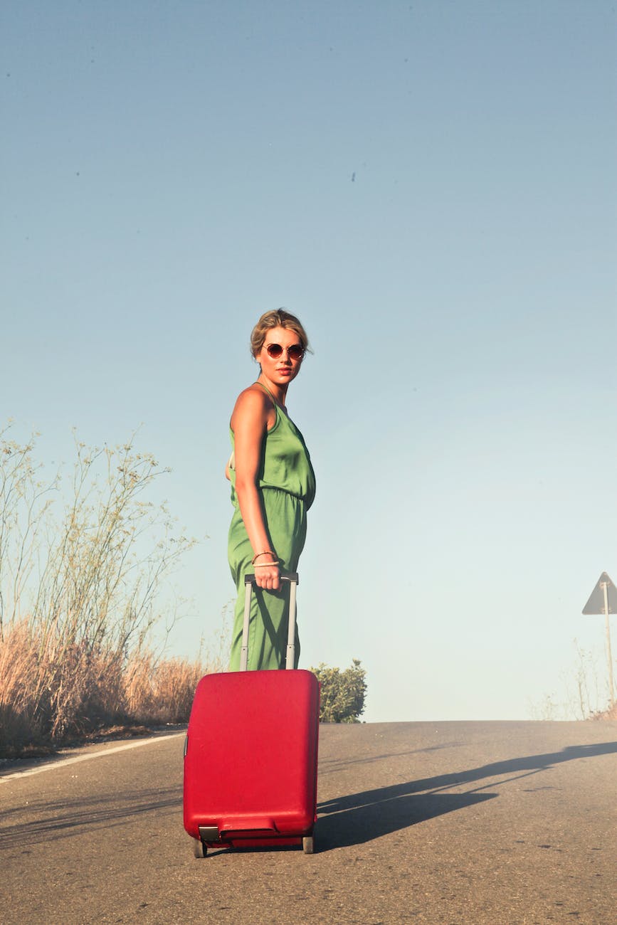 photo of a woman holding her luggage