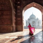 Visit India - The Taj Mahal through an arched gate