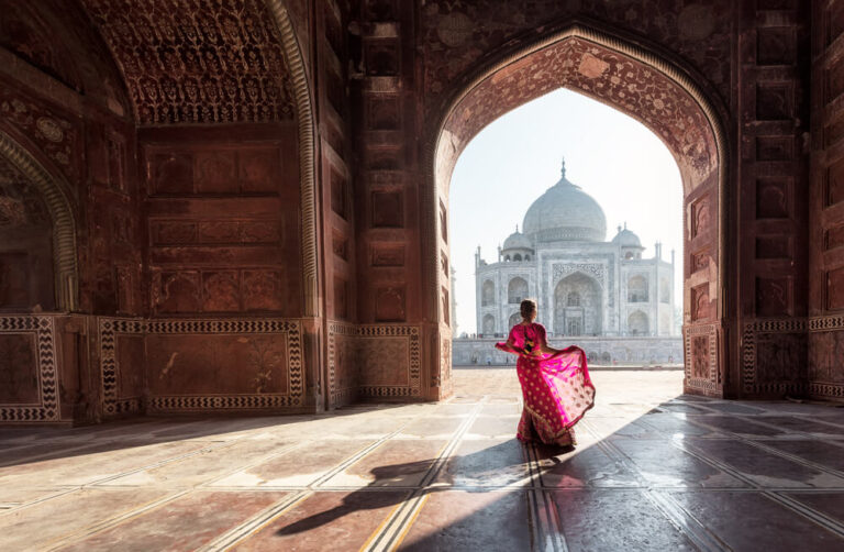 Visit India - The Taj Mahal through an arched gate