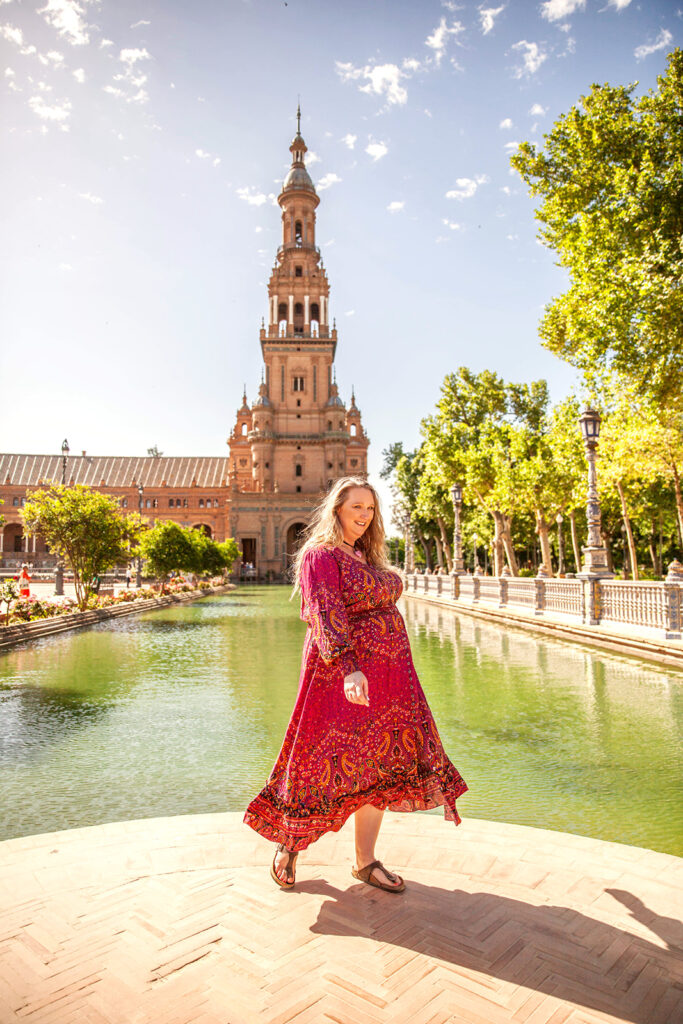 Woman in hot pick dress in front of canall in Spain